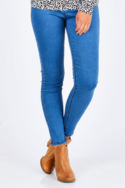 Model Chelsea wearing size 10 of the Mason Jean in colour Azure (Blue), from the front, cropped image