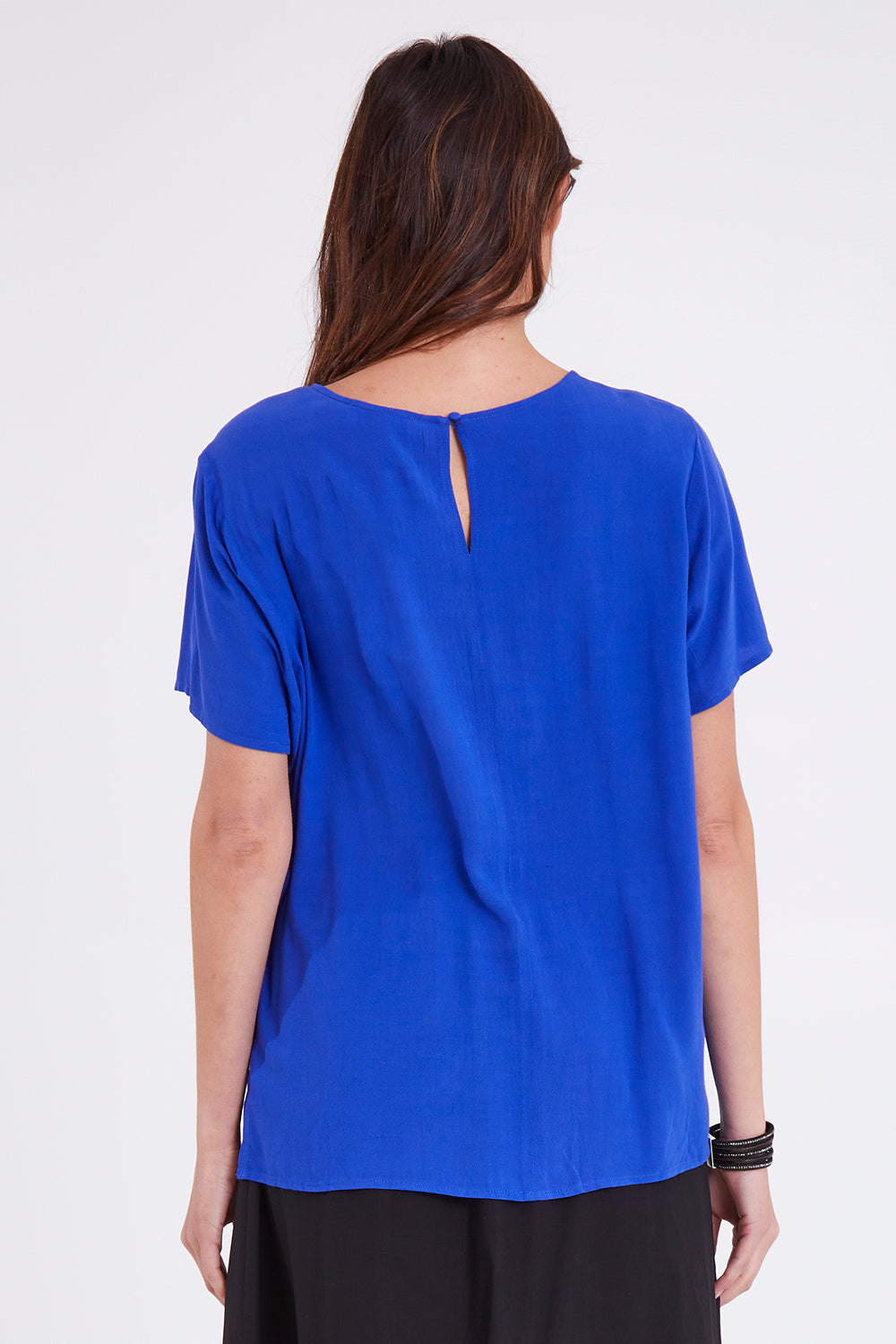 Model Madeline wearing size 10 of the Sangria Top in colour Decoblue (Blue), from the back