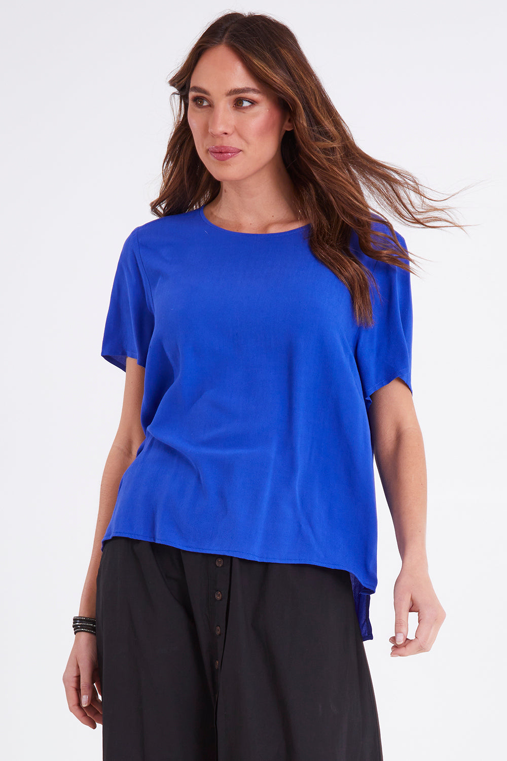 Model Madeline wearing size 10 of the Sangria Top in colour Decoblue (Blue), from the front, cropped image