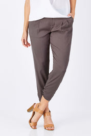 Model Anna wearing size 10 of The Best Seller Pant in colour Castlerock (Green), from the front, cropped image