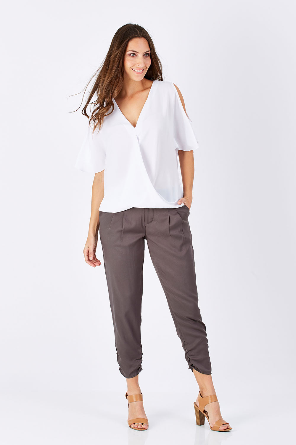 Model Anna wearing size 10 of The Best Seller Pant in colour Castlerock (Green), from the front, showing the whole outfit