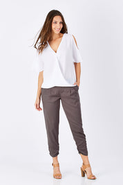 Model Anna wearing size 10 of The Best Seller Pant in colour Castlerock (Green), from the front, showing the whole outfit
