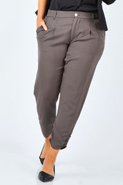 Model Laura wearing size 14 of The Best Seller Pant in colour Castlerock (Green), from the front, cropped image