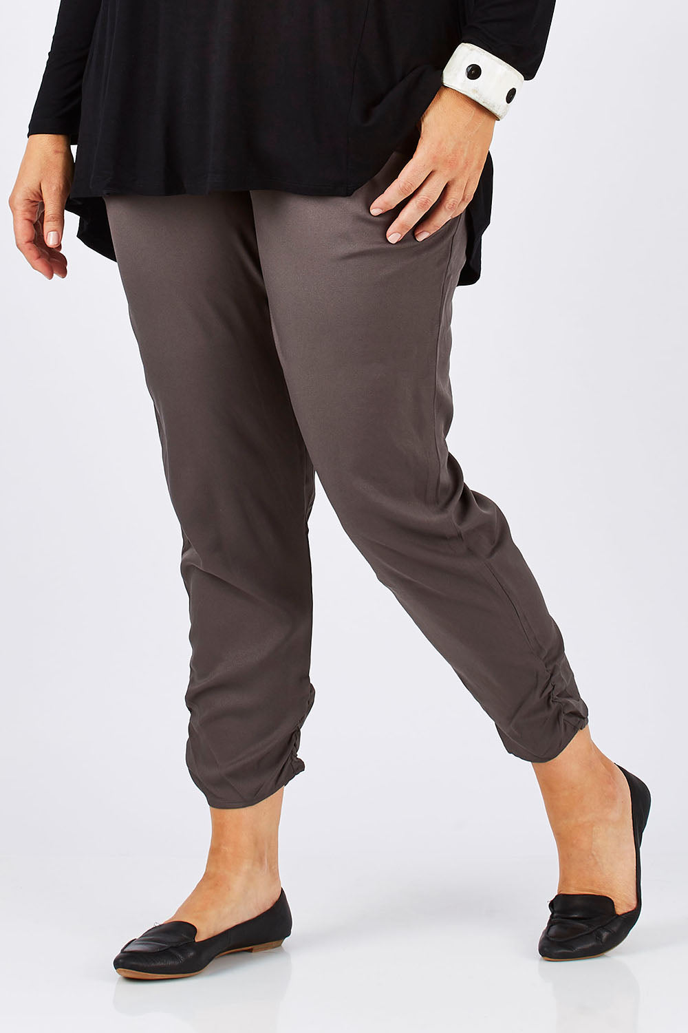 Model Ljubenka wearing size 18 of The Best Seller Pant in colour Castlerock (Green), from the front, cropped image