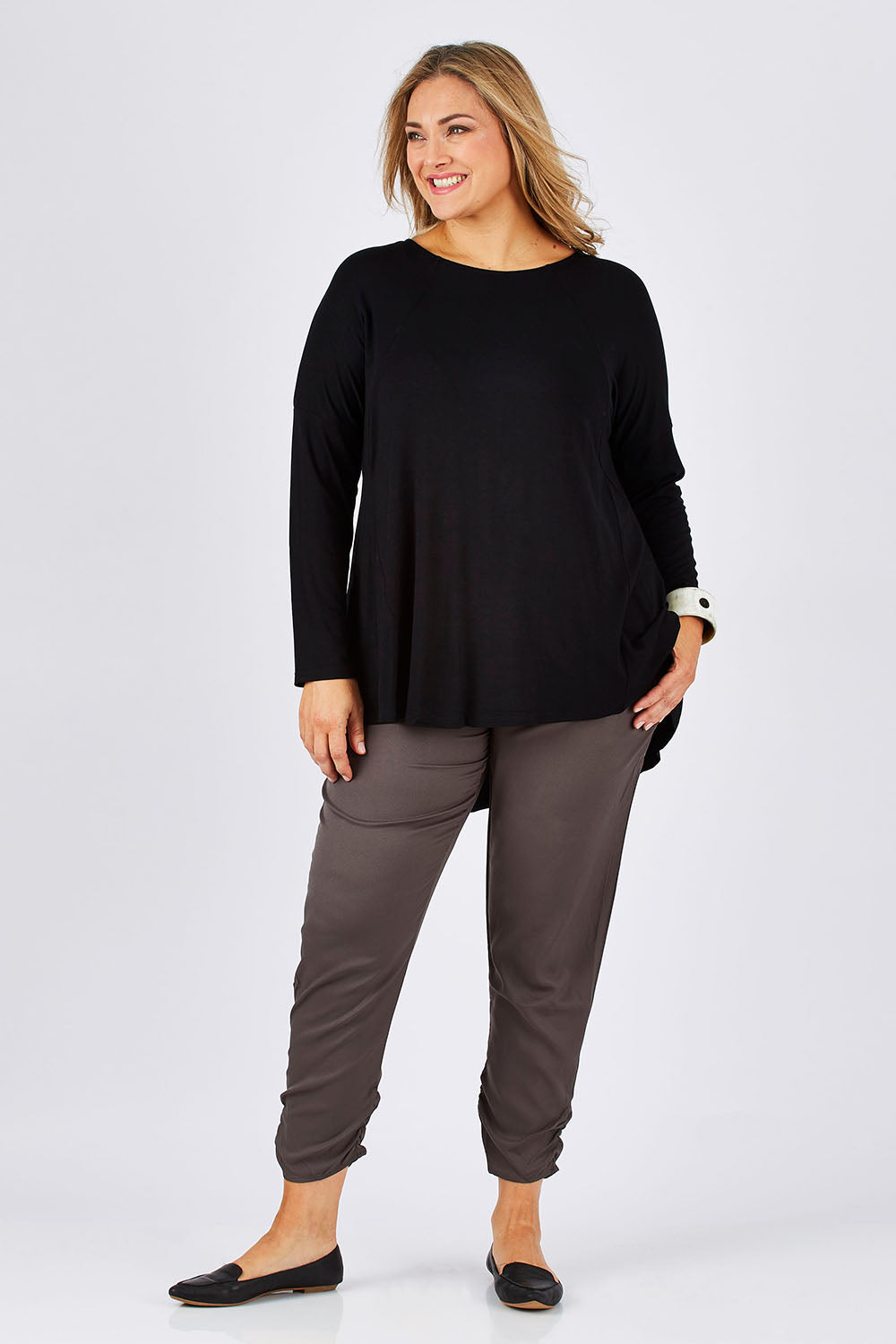 Model Ljubenka wearing size 18 of The Best Seller Pant in colour Castlerock (Green), from the front, showing the whole outfit