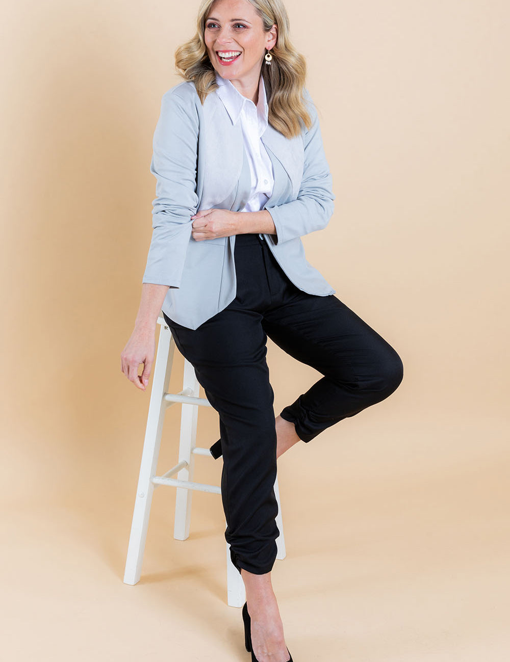 Model Brooke wearing size 10 of The Best Seller Pant in colour JetBlack (Black), from the front, showing the whole outfit