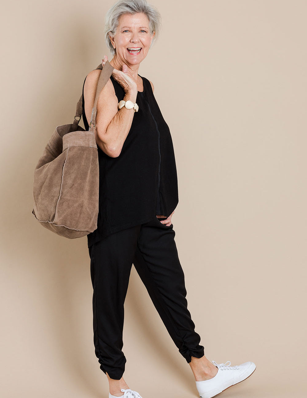 Model Elise wearing size 10 of The Best Seller Pant in colour JetBlack (Black), from the front, showing the whole outfit