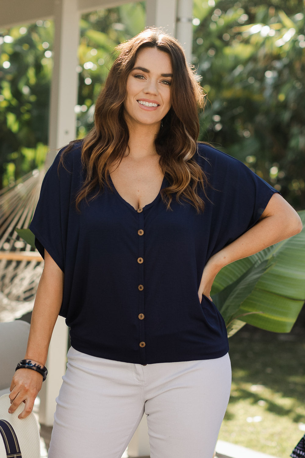Model Laura wearing size 14 of The Relaxed Button Bamboo Tee in colour Navy (Blue), from the front, showing the whole outfit