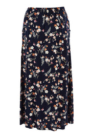 Product shot of The Drawstring Maxi Skirt in colour Fleur (Black), from the back