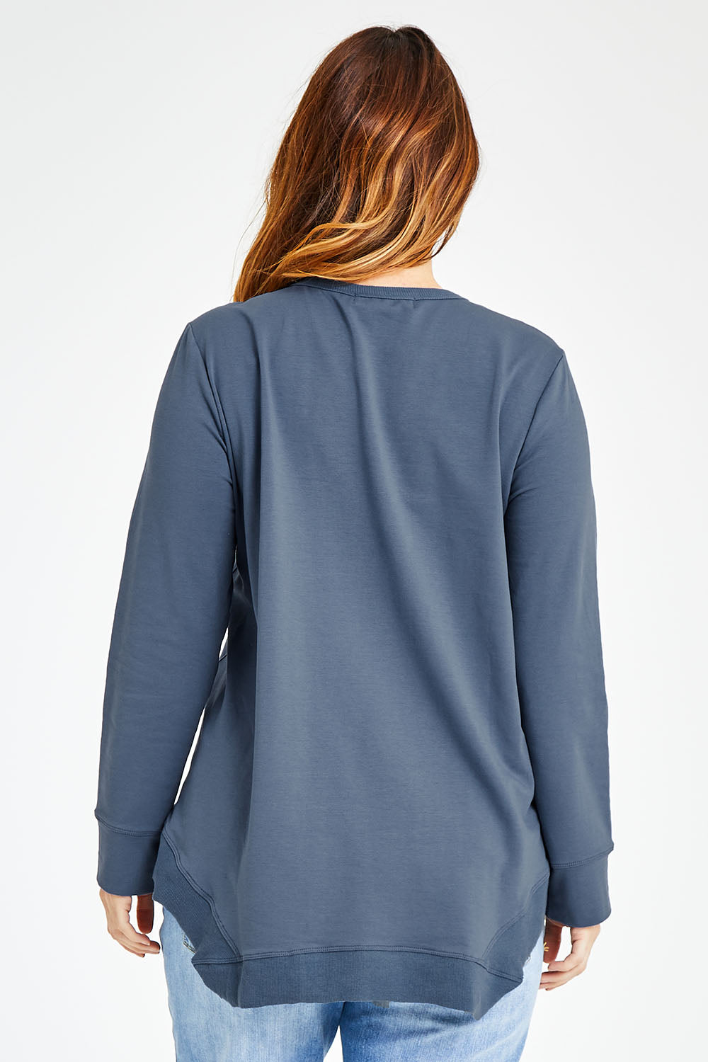 Model Laura wearing size 14 of The Hem Detail Sweater in colour Denimblue (Blue), from the back