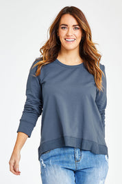 Model Laura wearing size 14 of The Hem Detail Sweater in colour Denimblue (Blue), from the front, cropped image