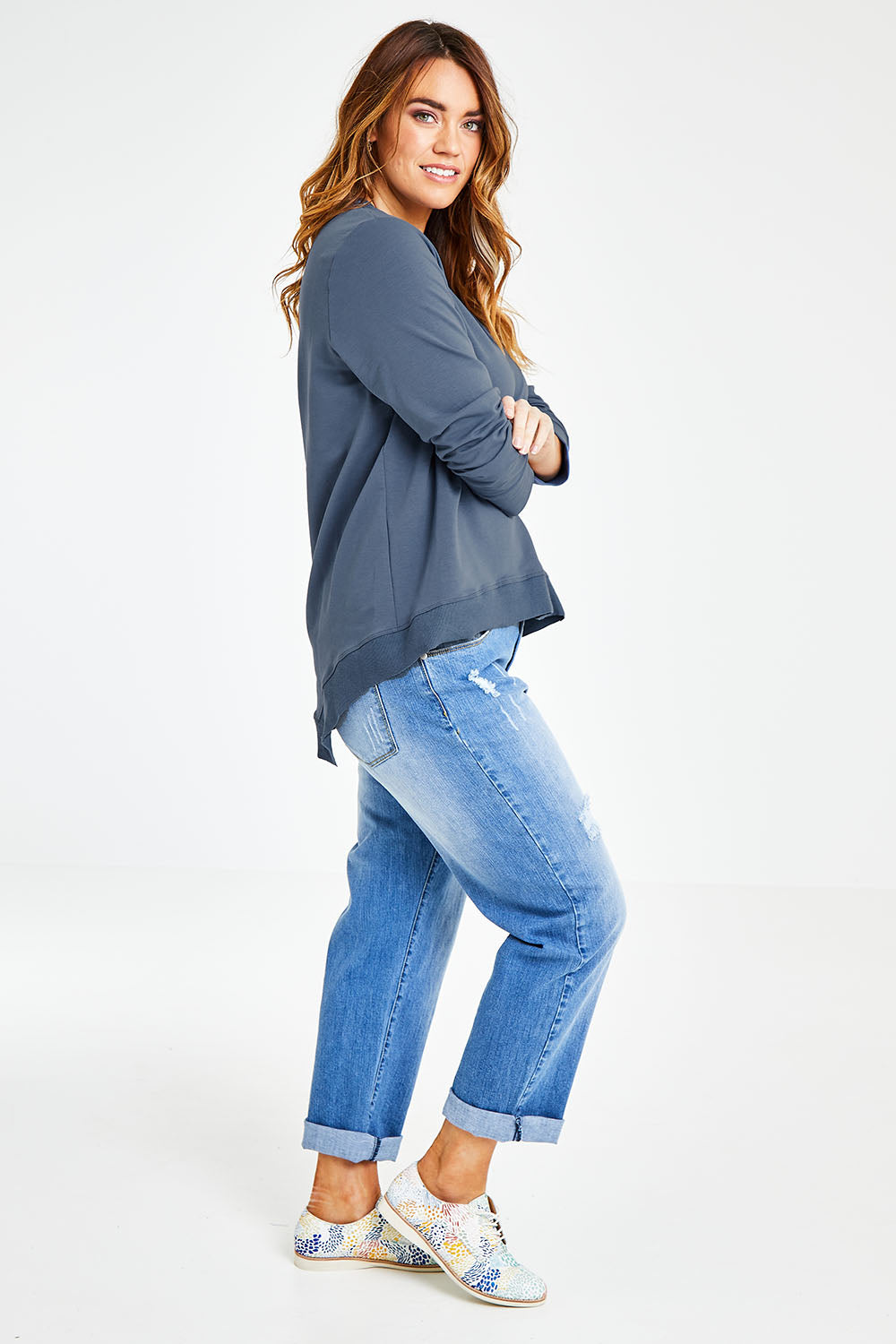 Model Laura wearing size 14 of The Hem Detail Sweater in colour Denimblue (Blue), from the front, showing the whole outfit