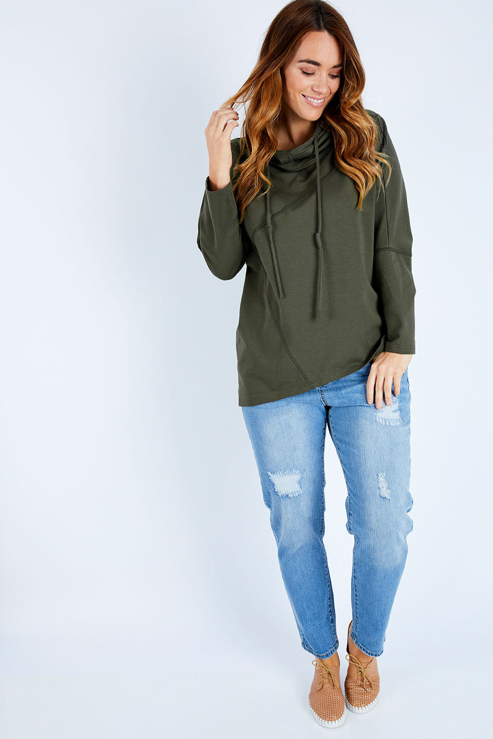 Model Laura wearing size 14 of The Cowl Neck Hoody in colour Khaki (Green), from the front, showing the whole outfit