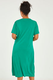Model Noli wearing size 14 of The Bamboo Blend Button Dress in colour Jade (Green), from the back