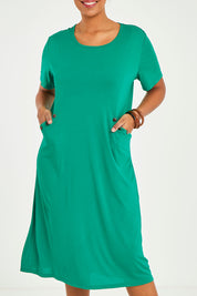 Model Noli wearing size 14 of The Bamboo Blend Button Dress in colour Jade (Green), from the front, cropped image
