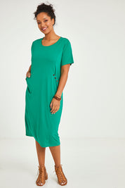Model Noli wearing size 14 of The Bamboo Blend Button Dress in colour Jade (Green), from the front, showing the whole outfit