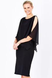 Model Maddy wearing size 10 of The Overlay Midi Dress in colour Black (Black), from the front, cropped image