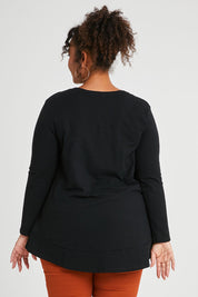 Model Alexis wearing size 16 of The Long Sleeve Swing Tee in colour Black (Black), from the back