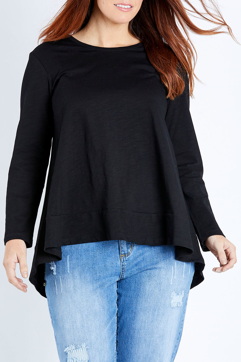 Model Laura wearing size 12 of The Long Sleeve Swing Tee in colour Black (Black), from the front, cropped image
