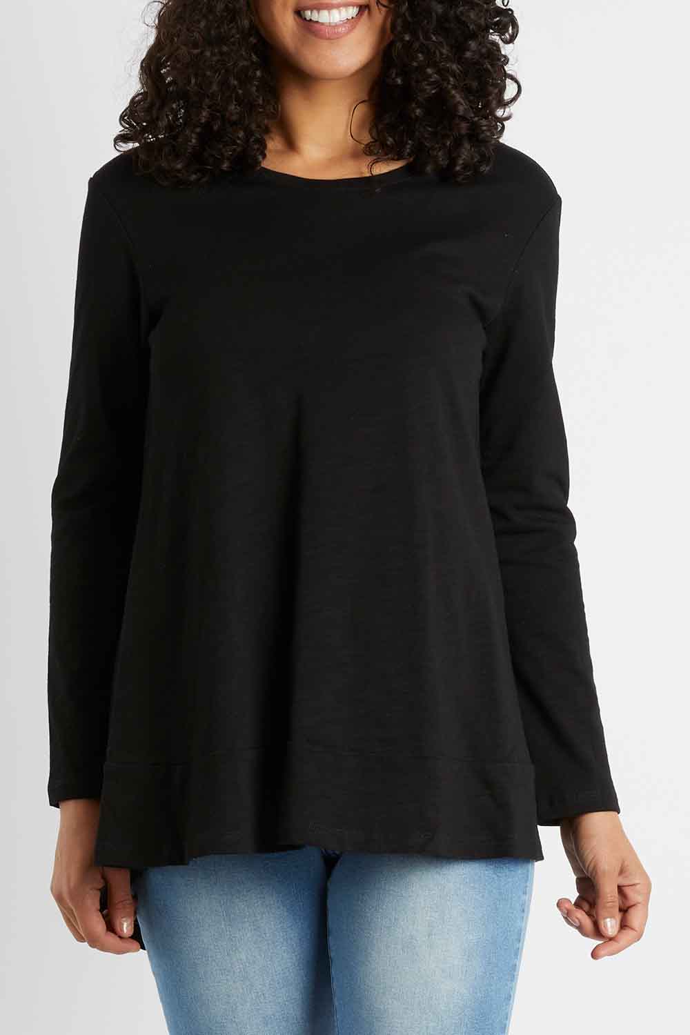 Model Pamela wearing size 10 of The Long Sleeve Swing Tee in colour Black (Black), from the front, cropped image