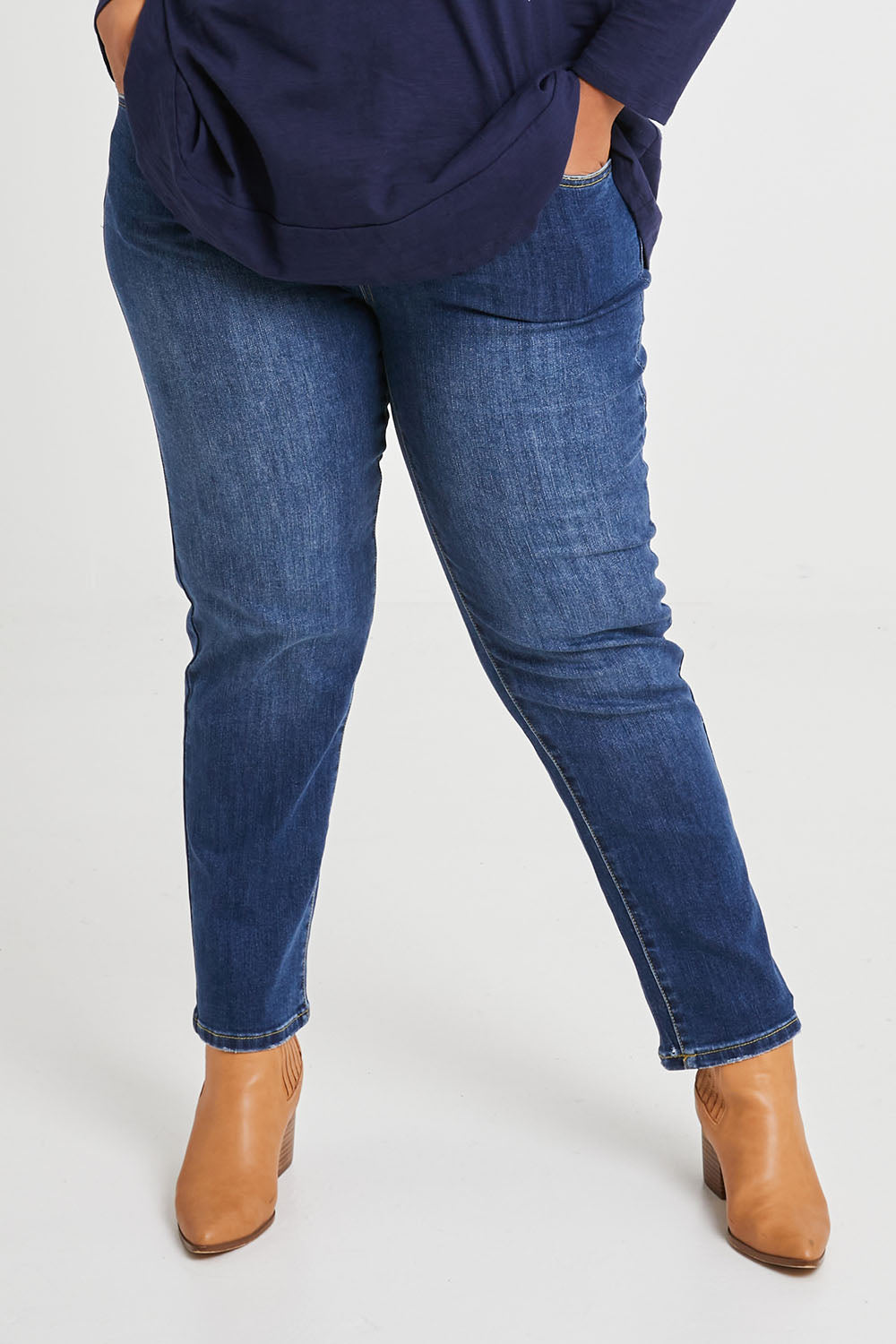 Model Alexis wearing size 16 of The Boyfriend Jean in colour Mediumblue (Blue), from the front, cropped image