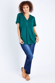 Model Lala wearing size 10 of The Stitch Detail Short Sleeve Top in colour Pinegreen (Green), from the front, showing the whole outfit