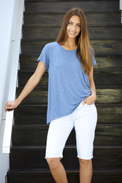 Model Anna wearing size 10 of The Pull On Short in colour White (White), from the front, showing the whole outfit
