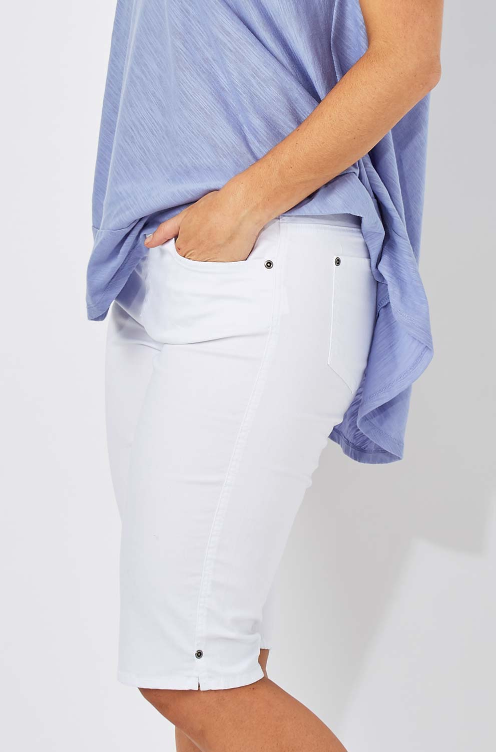Model Laura wearing size 12 of The Pull On Short in colour White (White), from the front, cropped image