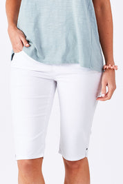 Model Perrie wearing size 10 of The Pull On Short in colour White (White), from the front, cropped image