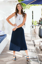 Model Amanda wearing size 10 of The Recycled Pull On Skirt in colour Navy (Blue), from the front, showing the whole outfit