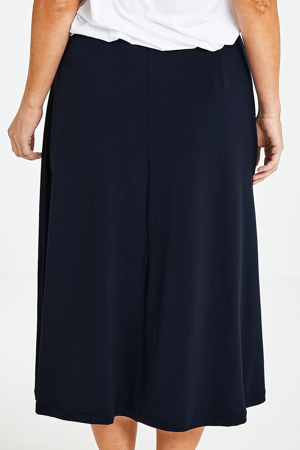 Model Laura wearing size 14 of The Recycled Pull On Skirt in colour Navy (Blue), from the back