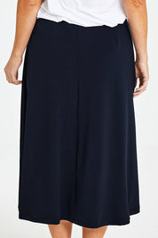 Model Laura wearing size 14 of The Recycled Pull On Skirt in colour Navy (Blue), from the back