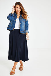 Model Laura wearing size 14 of The Recycled Pull On Skirt in colour Navy (Blue), from the front, showing the whole outfit