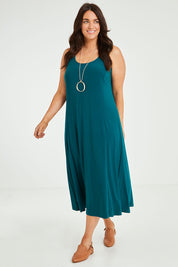 Model Laura wearing size 14 of The Recycled A Line Midi Dress in colour Deeplagoon (Green), from the front, showing the whole outfit
