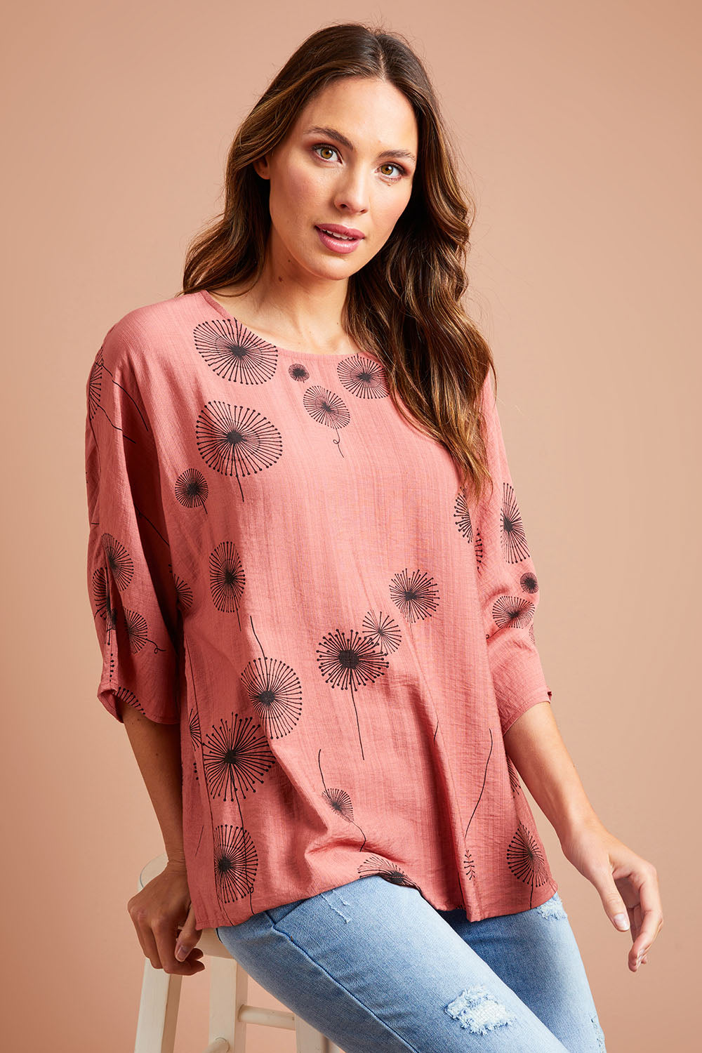 Model Madeline wearing size 10 of The Relax Fit Printed Top in colour Rosecopper (Pink), from the front, showing the whole outfit