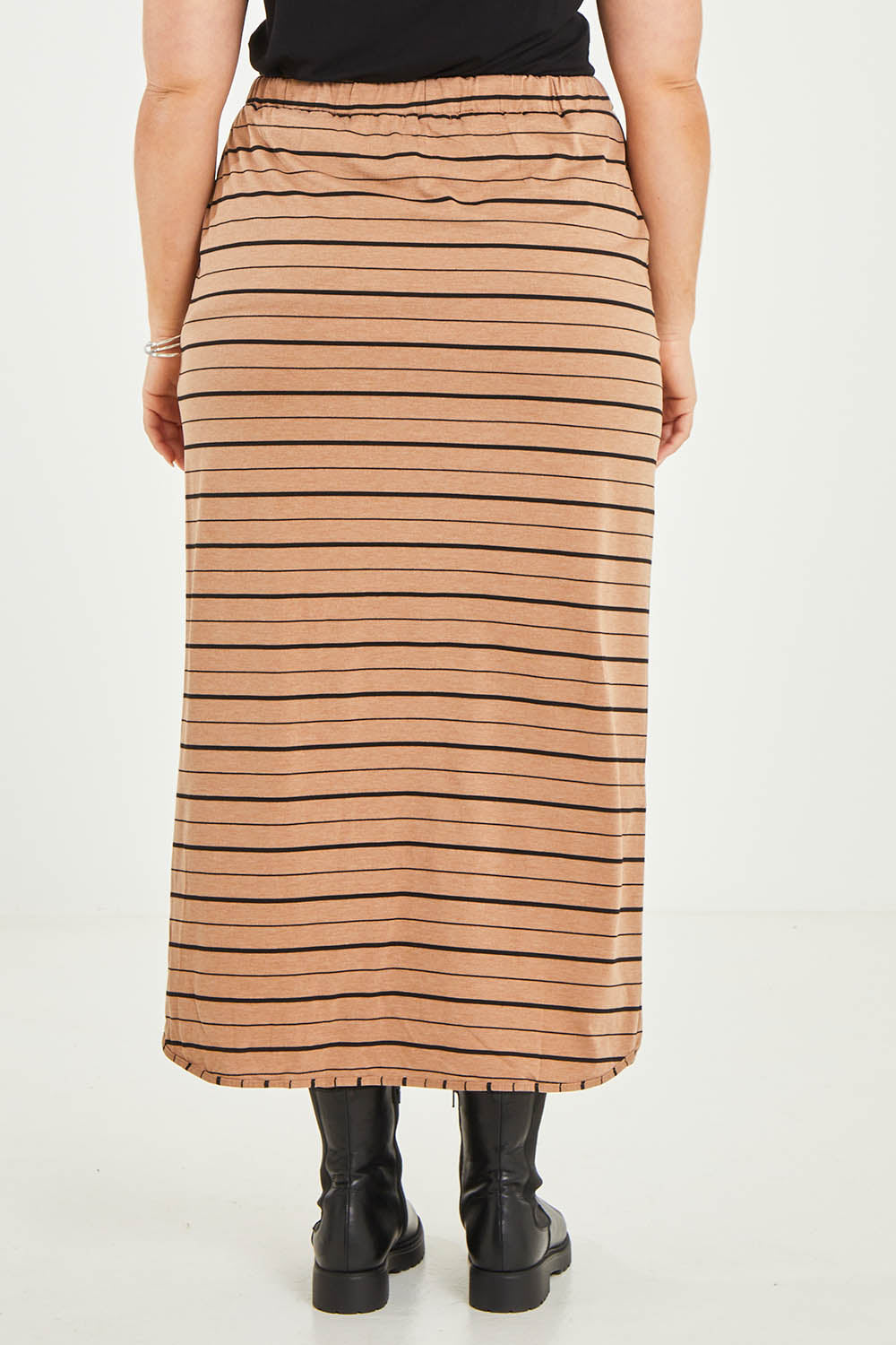 Model Katie wearing size 16 of The Pull On Maxi Skirt in colour Camelblack (Black), from the back