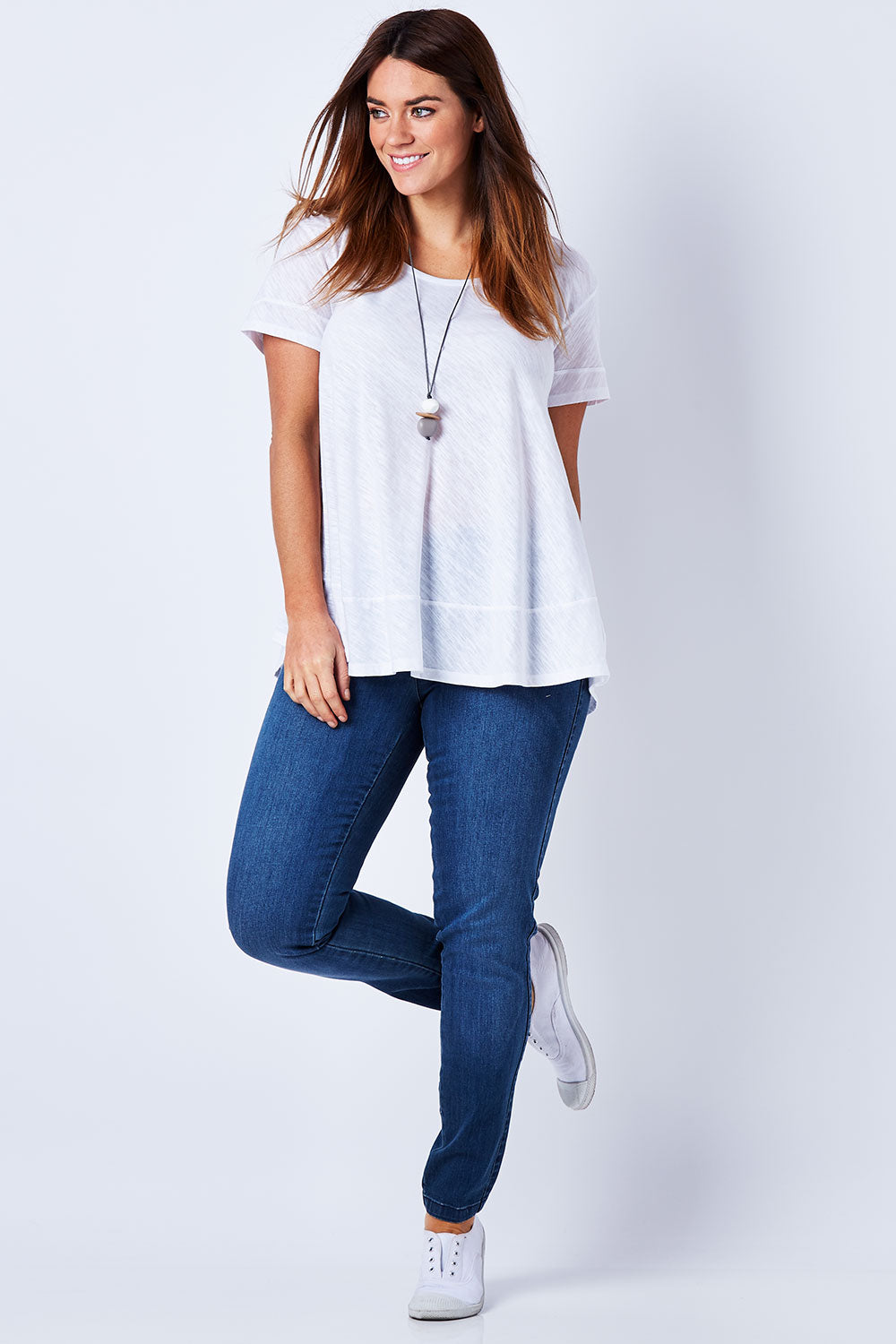 Model Laura wearing size 12 of The Everyday Jegging in colour Denim (Blue), from the front, showing the whole outfit