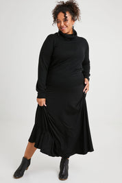 Model Alexis wearing size 16 of The Best Seller Skirt in colour JetBlack (Black), from the front, showing the whole outfit