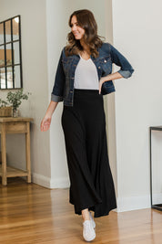 Model Madeline wearing size 10 of The Best Seller Skirt in colour JetBlack (Black), from the front, showing the whole outfit