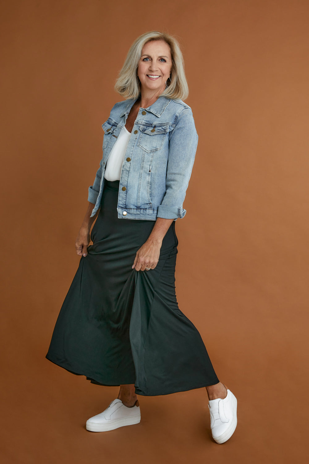 Model Sandy wearing size 10 of The Best Seller Skirt in colour JetBlack (Black), from the front, showing the whole outfit