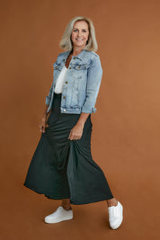 Model Sandy wearing size 10 of The Best Seller Skirt in colour JetBlack (Black), from the front, showing the whole outfit