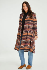 Model Laura wearing size 14 of The Swing Knit Cardigan in colour Winestripe (Purple), from the front, showing the whole outfit