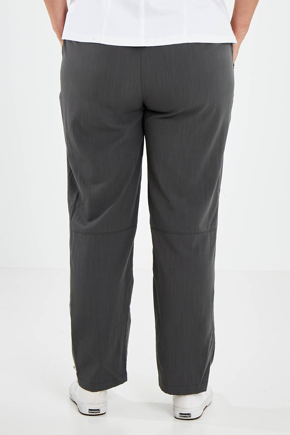 Model Jess wearing size 14 of The Easy Wear Pant in colour Ashgreen (Green), from the back