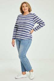 Model Fiona wearing size 16 of The Striped Curved Hem Long Sleeve Tee in colour Cornflower (Blue), from the front, showing the whole outfit