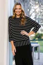 Model Tahlia wearing size 10 of The Striped Blocked Tee in colour Blackwhite (Black), from the front, showing the whole outfit
