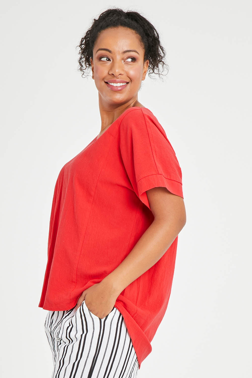 Model Noli wearing size 14 of The Relaxed Fit Woven Tee in colour Red (Red), from the front, cropped image