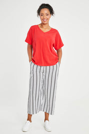 Model Noli wearing size 14 of The Relaxed Fit Woven Tee in colour Red (Red), from the front, showing the whole outfit