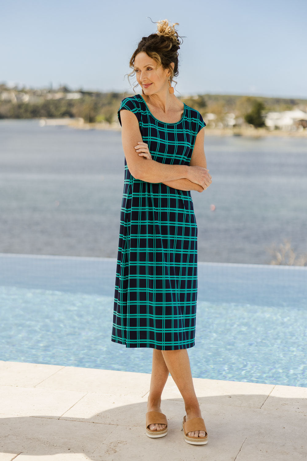 Model Emma wearing size 10 of The Keepers Check Sun Dress in colour Navycheck (Blue), from the front, showing the whole outfit