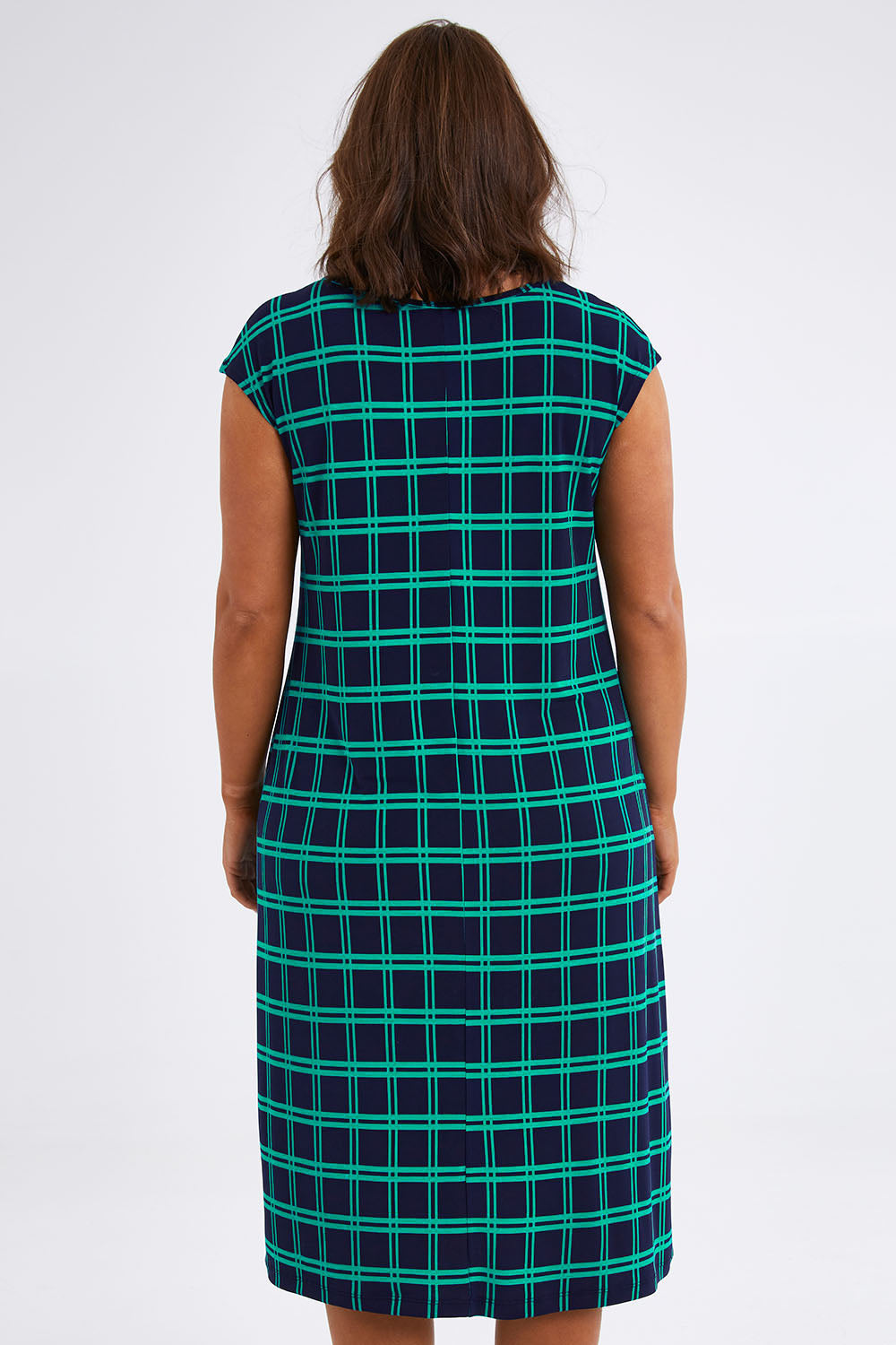 Model Monique wearing size 14 of The Keepers Check Sun Dress in colour Navycheck (Blue), from the back