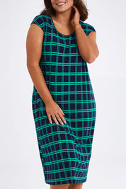 Model Monique wearing size 14 of The Keepers Check Sun Dress in colour Navycheck (Blue), from the front, cropped image